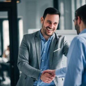 Man giving another man a handshake