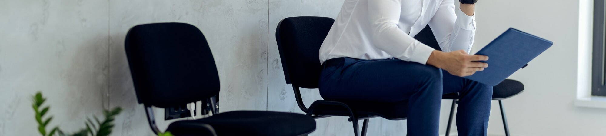 Man sitting on chair using tablet