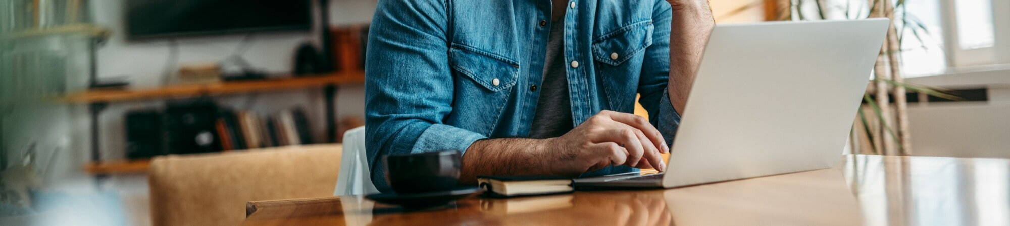 Man typing on laptop cropped